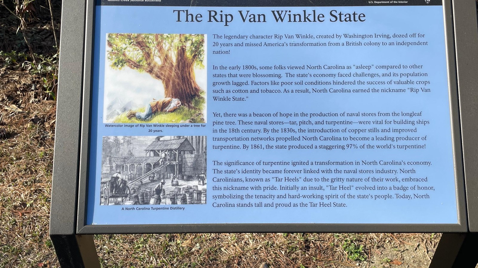 Light blue sign with two drawings on it and text