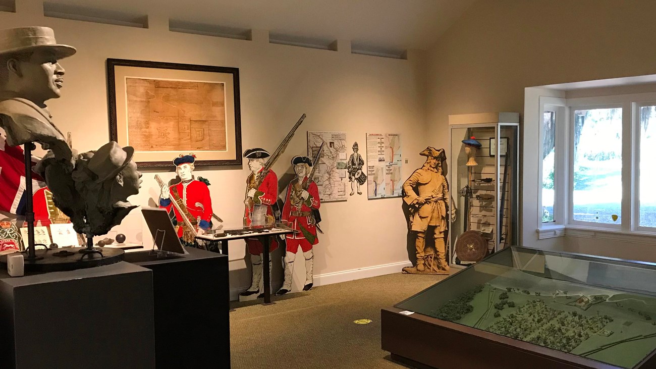 Museum exhibit area with information panels and large window