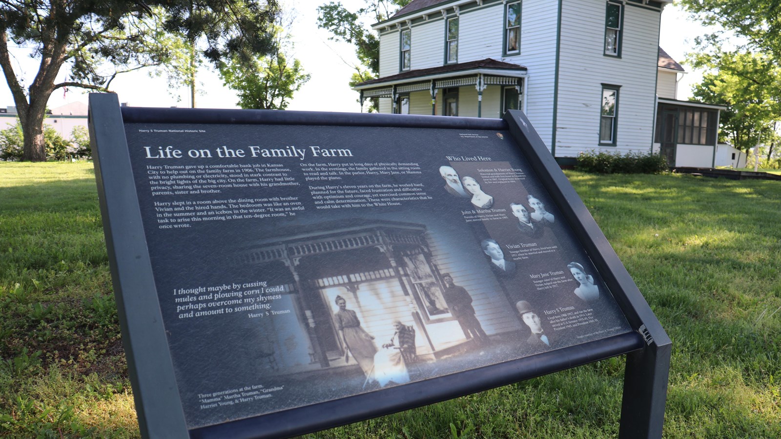 The Life on the Family Farm wayside in the foreground, the two-story Truman farm  in the background.