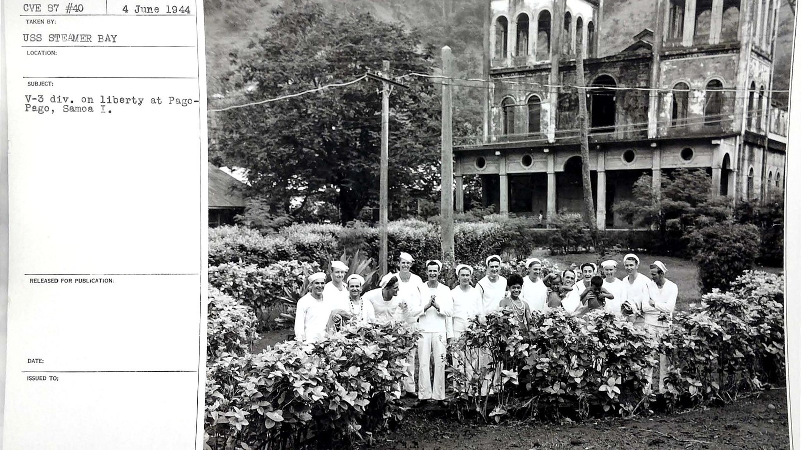 A group of people dressed in white stand in front of a church