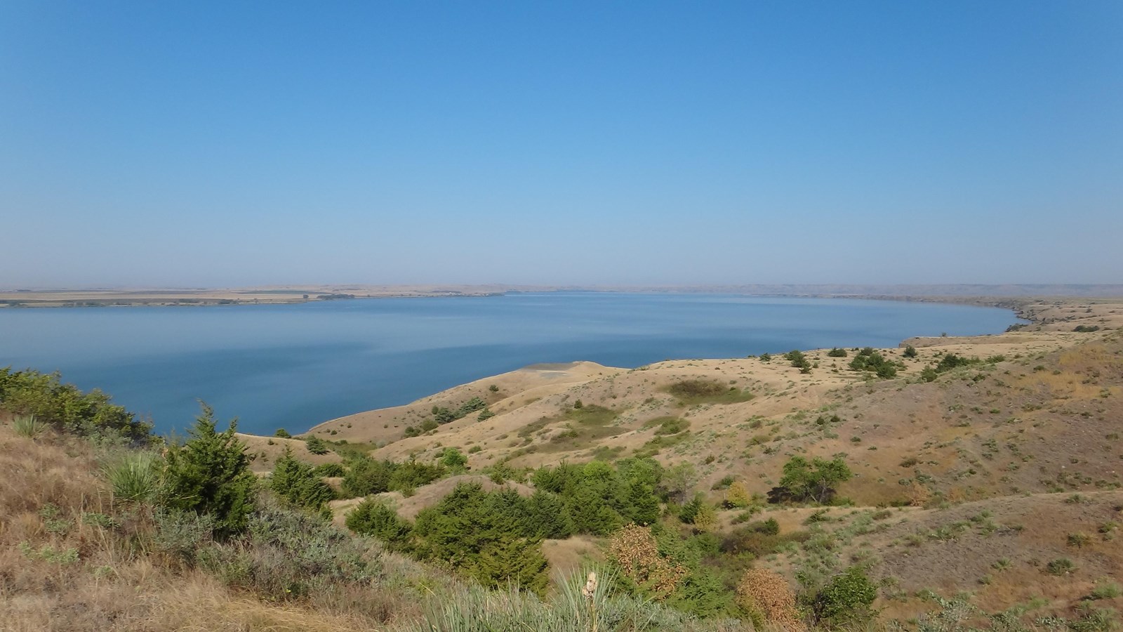 Grass upland with large river curving in the background