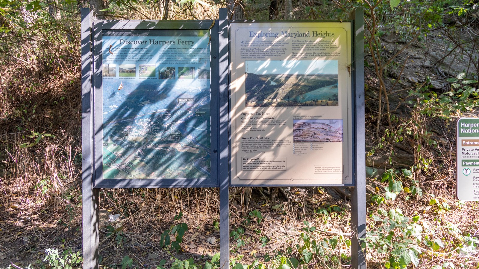 A map of Harpers Ferry is on the left sign, a picture of Maryland Heights is on the right sign.