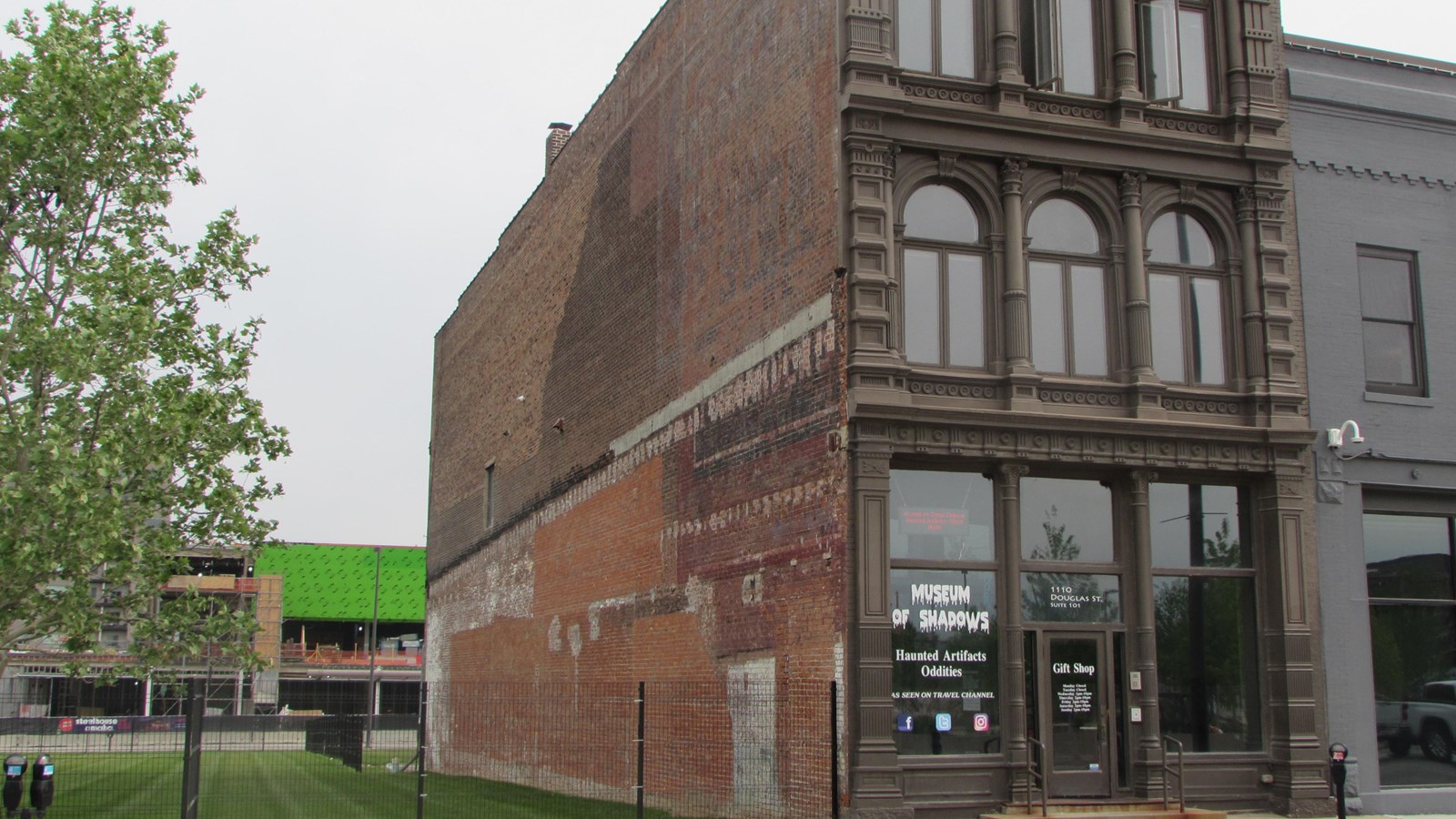 Three story commercial building. Cast-iron storefront. Three windows on second and third floors.