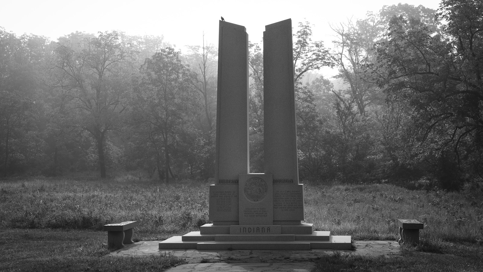 A black and white photograph of a large monument to the state of Indiana