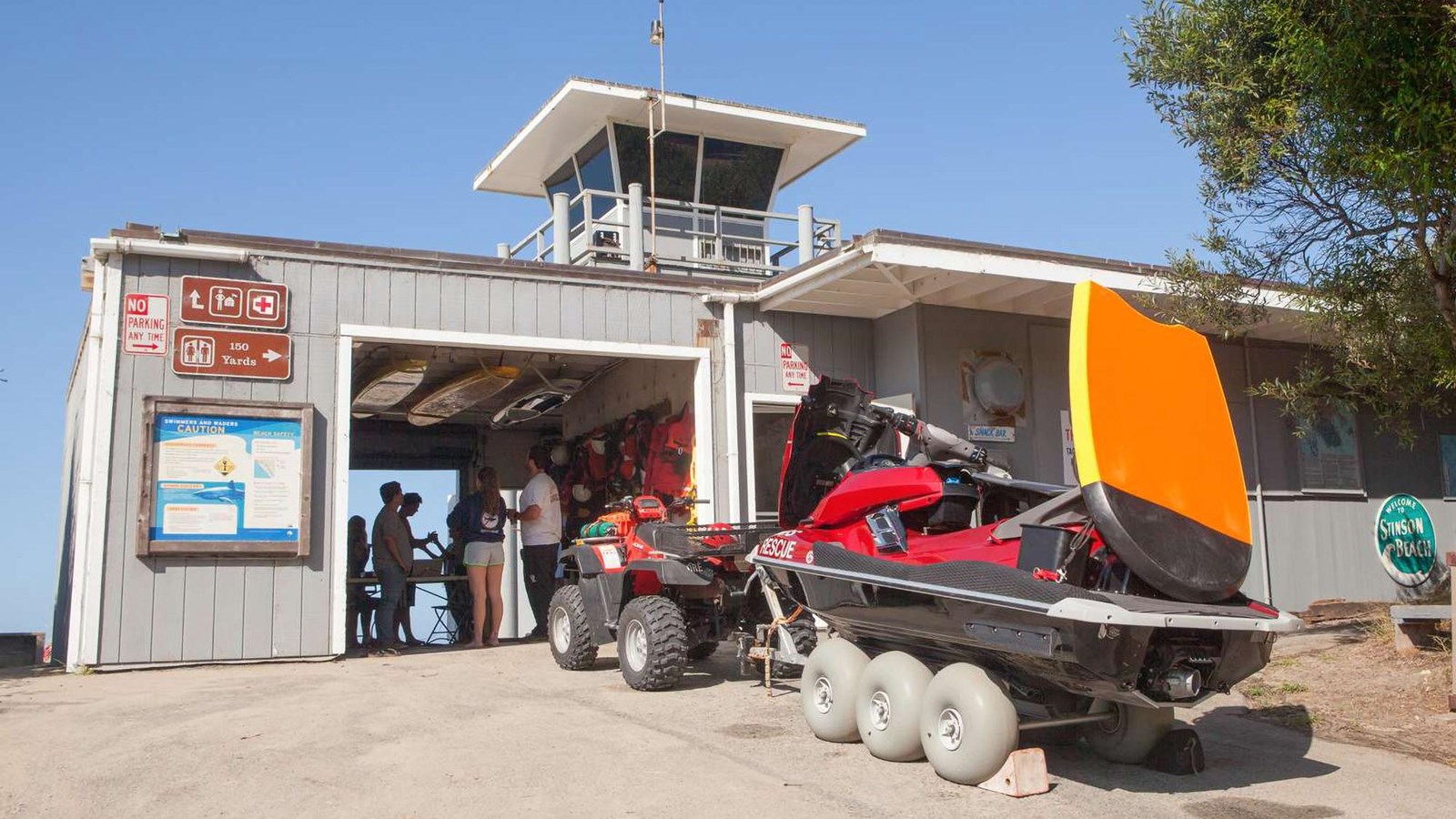 Stinson Beach lifeguard station with rescue equipment in front.