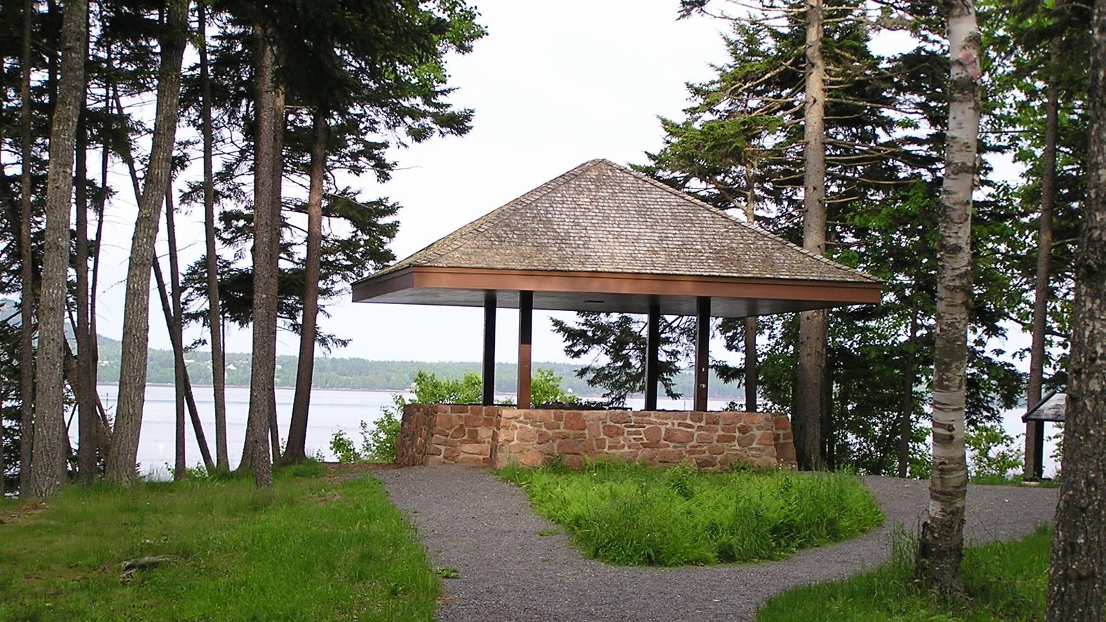A shelter at the end of a trail with views of a river and island