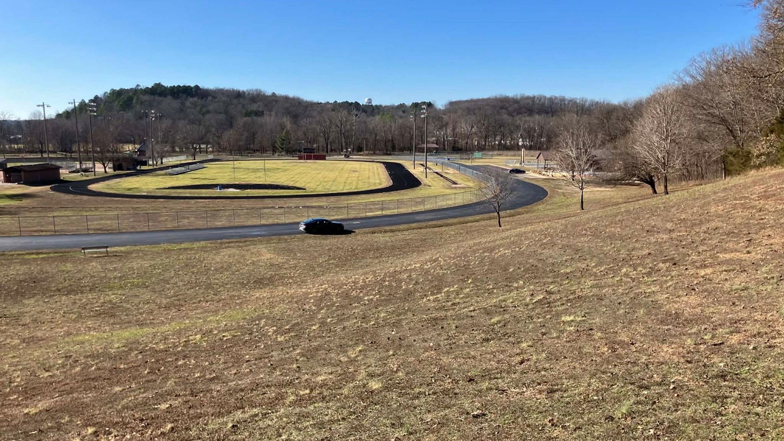 A grassy hill leads down to a 