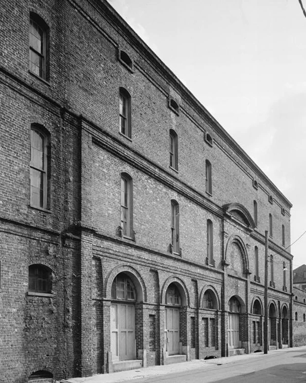 A three story brick building with arched doorway.