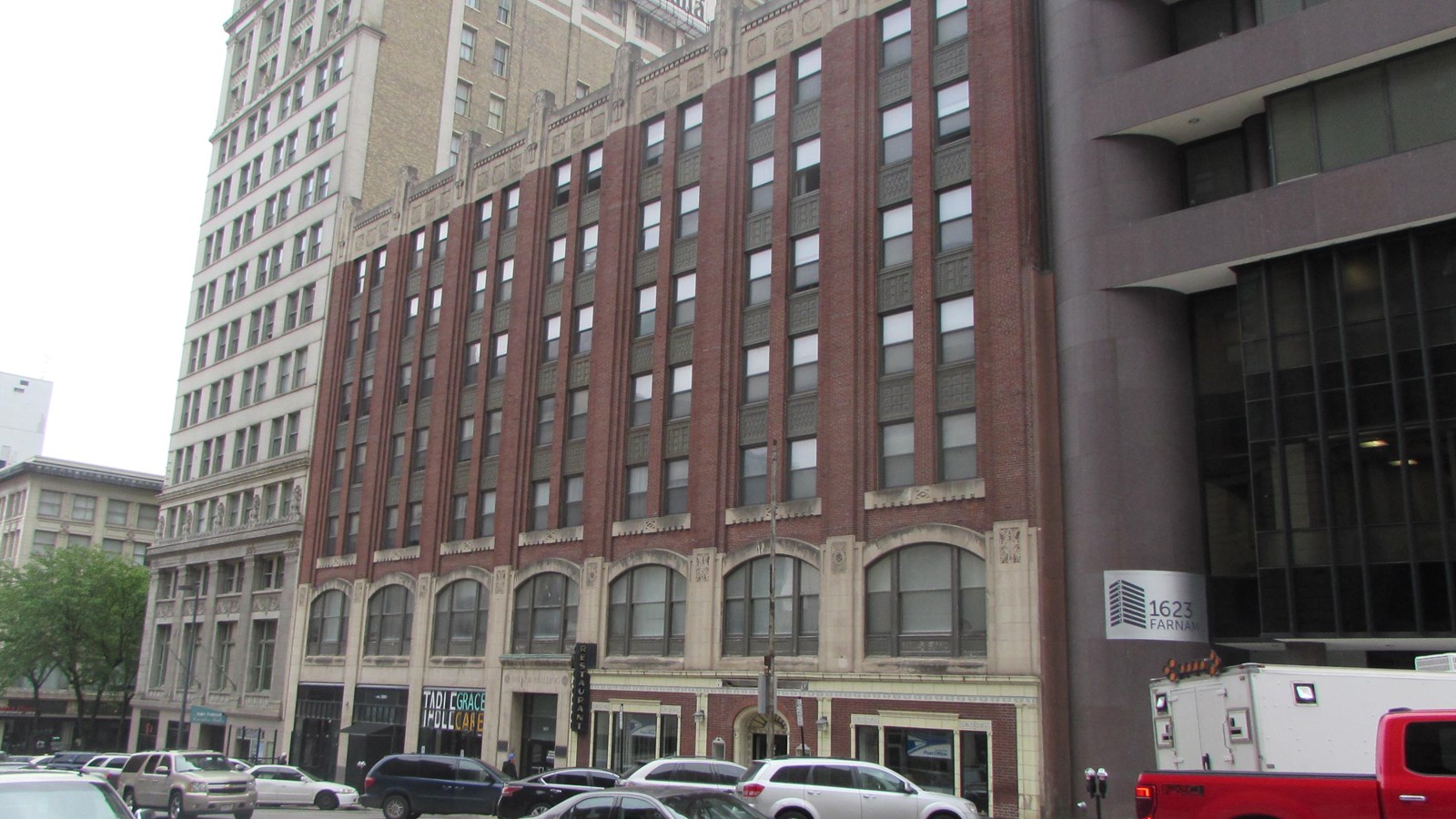 Seven story building. Two floors of stone façade, brick on upper floors. Large storefront windows.