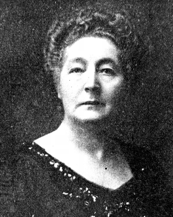 Portrait of a middle-aged woman in a boat-neck dress with hair pulled up into full bun