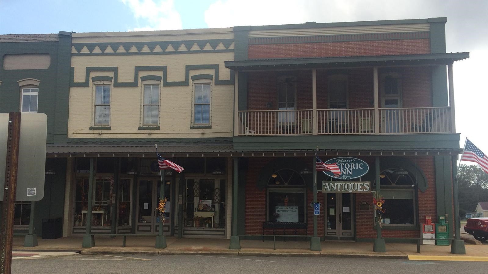 Plains Historic Inn and Antiques Mall a red brick building with a balcony 