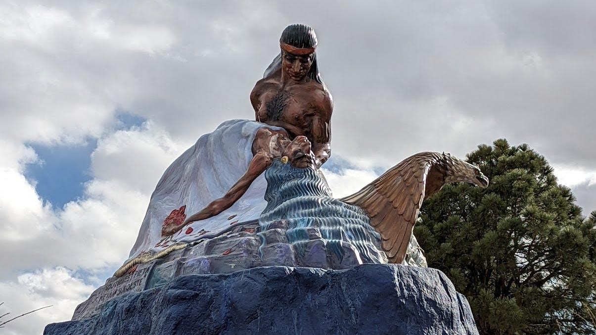 Sculpture with a blue base and two human figures