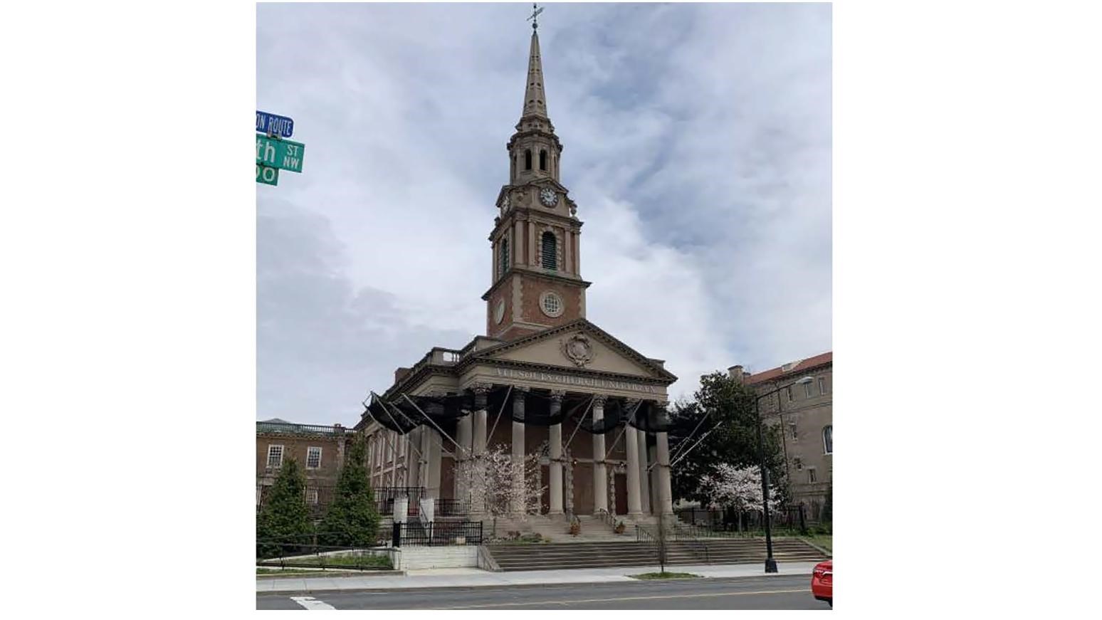 Church comprising a central sanctuary block, side wings, and steeple