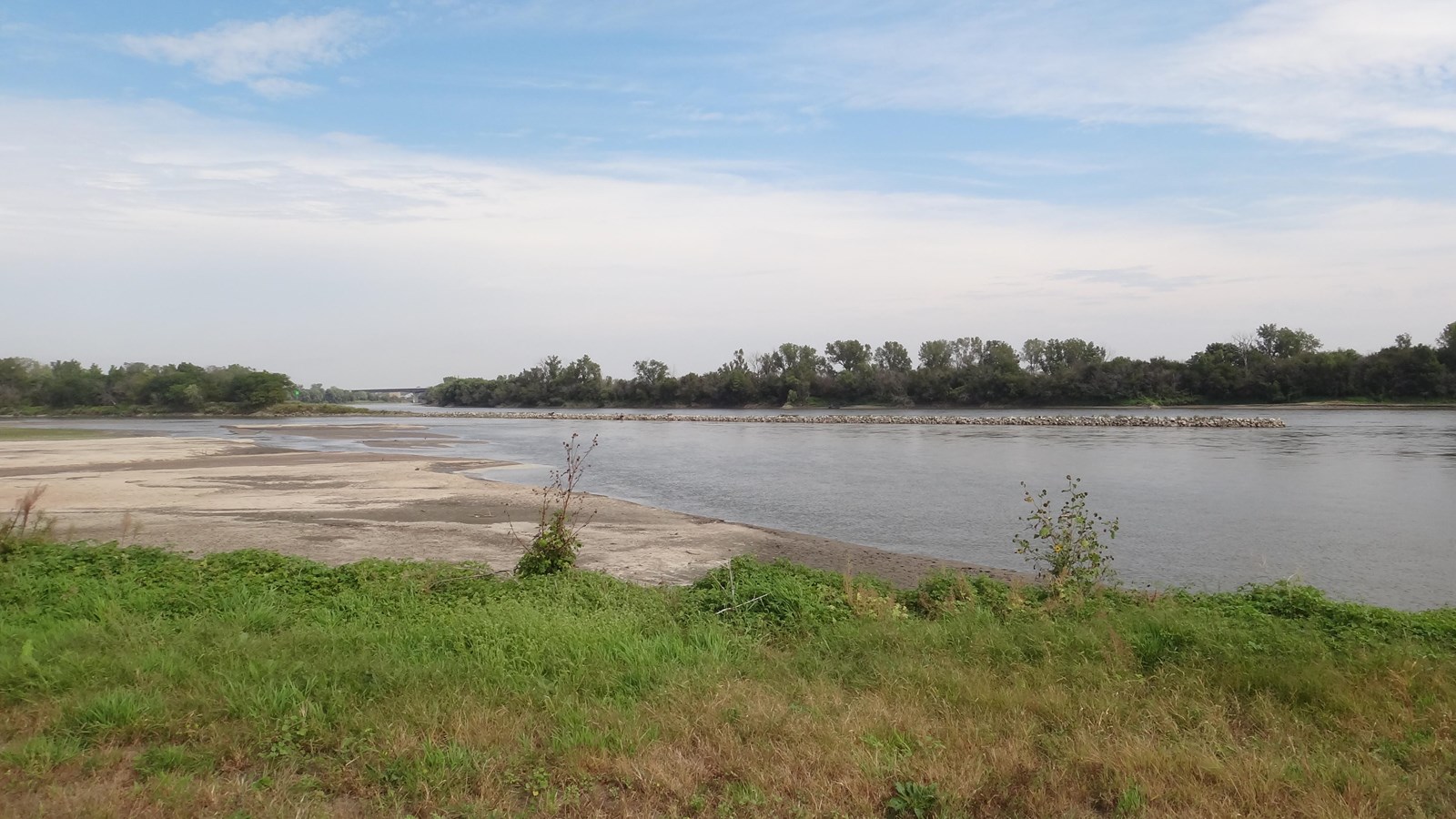 large wide river with sandbars in the foreground