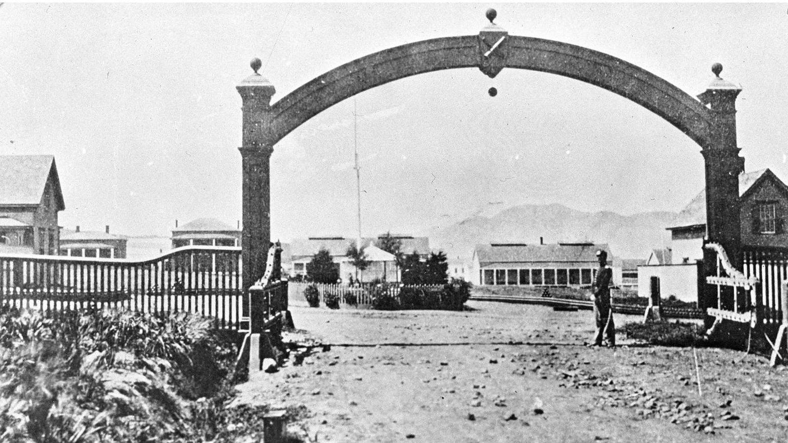 A soldier stands guard below an iconic archway at the Alameda entrance to the Presidio.