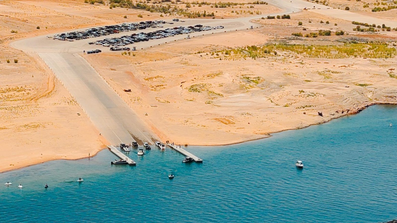 Aerial view of a concrete ramp on a desert lake.