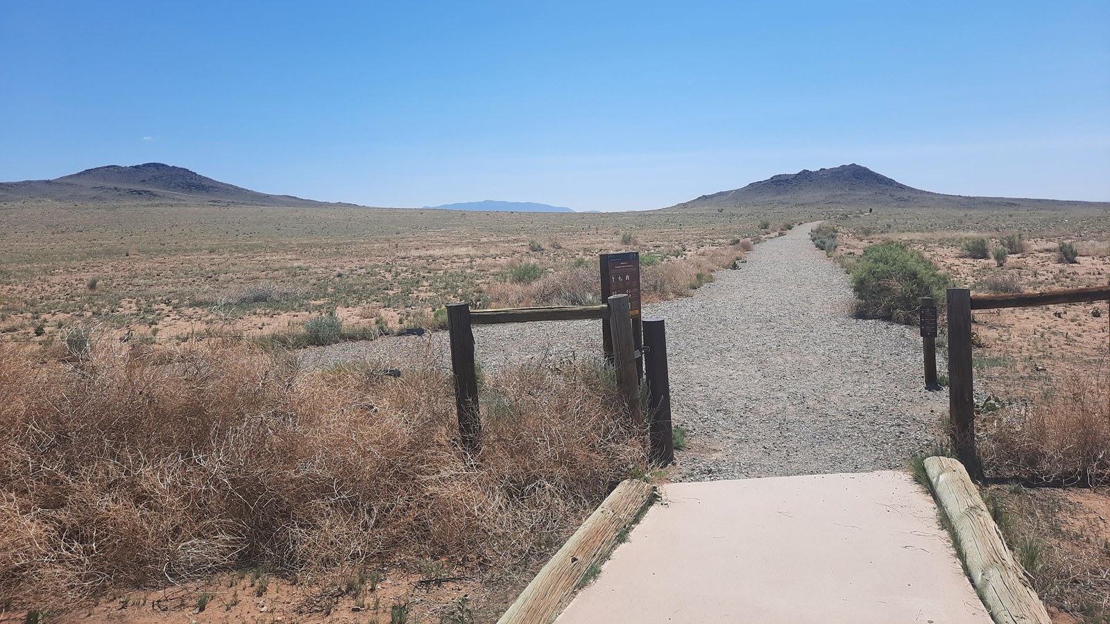 Trail heading towards two volcanoes.