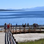 Visitors stroll along the boardwalks near the shore of Yellowstone Lake.
