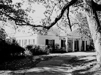 moderate sized house with a columned portico in the front