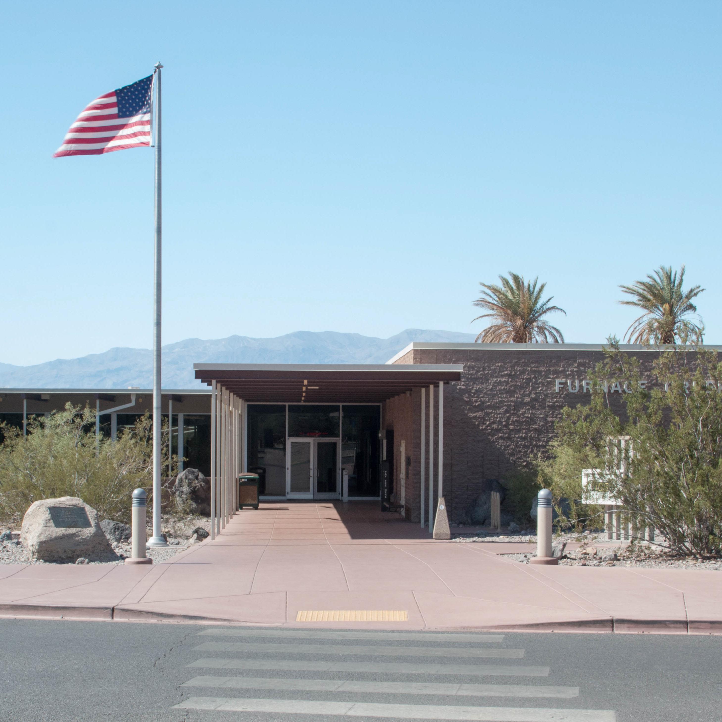 a one story block building and flag pole