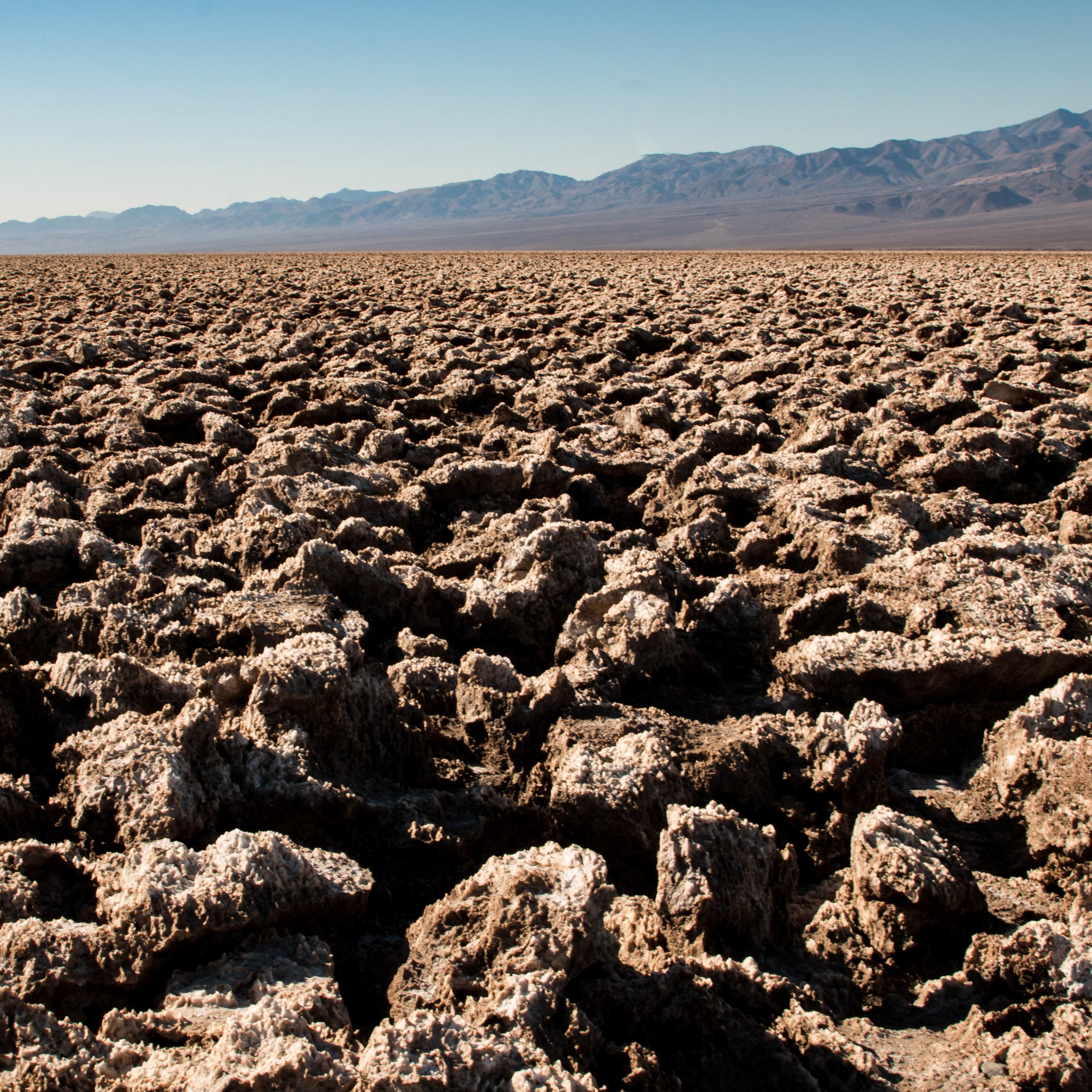 Sharp, eroded salt formations stretch into the background. 
