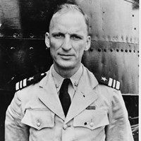 Black and white portrait of a man in a light colored military uniform.