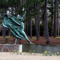 Brookgreen Gardens with oxidized bronze statue in foreground. By anoldent, , CC BY-SA 2.0.