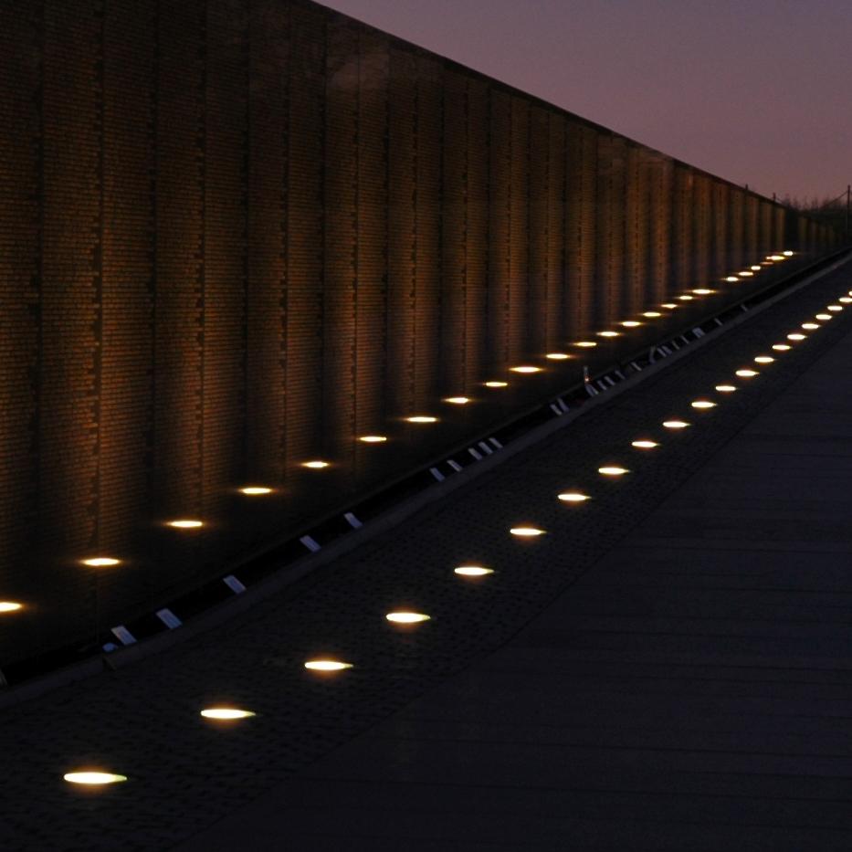 A twilight photo of the Vietnam Veterans Memorial leading toward the Washington Monument.