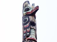 Top figure of a totem pole with sky in the background