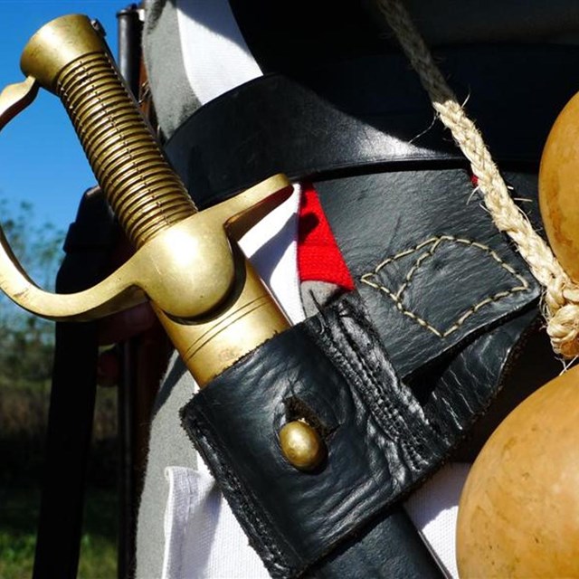Close-up of sword and gourd on belt of soldier