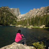 Visitor sitting and viewing Dream Lake