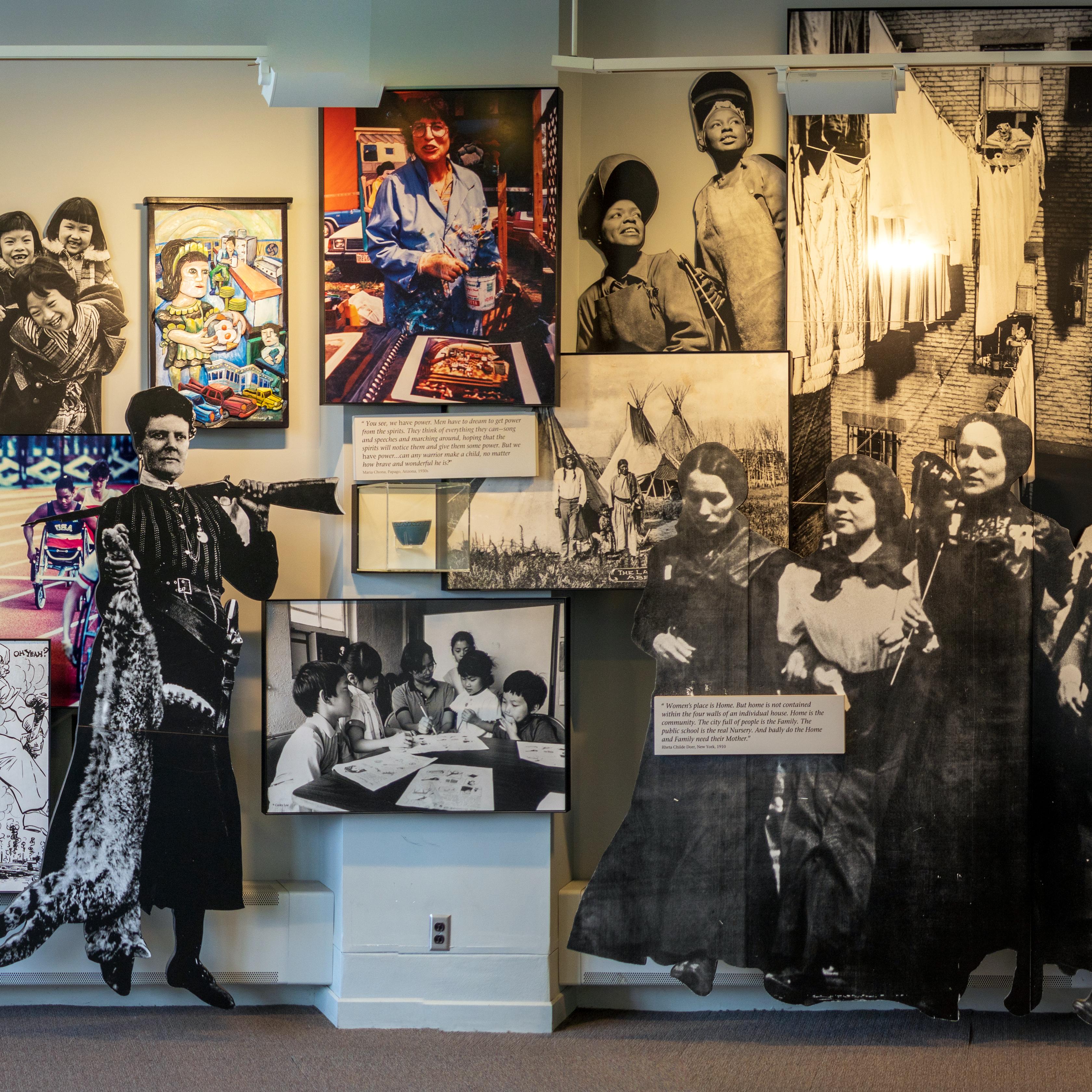 A wall of various photos in an exhibit.