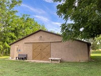 A brown-gray painted concrete barn.