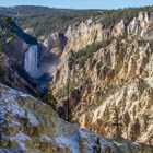 Lower Falls plunges into the yellowish-tan canyon.