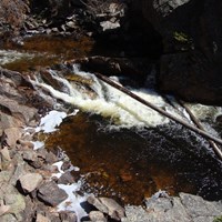 a pool of water with small waterfall