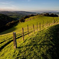 A fence with a mountain in the background