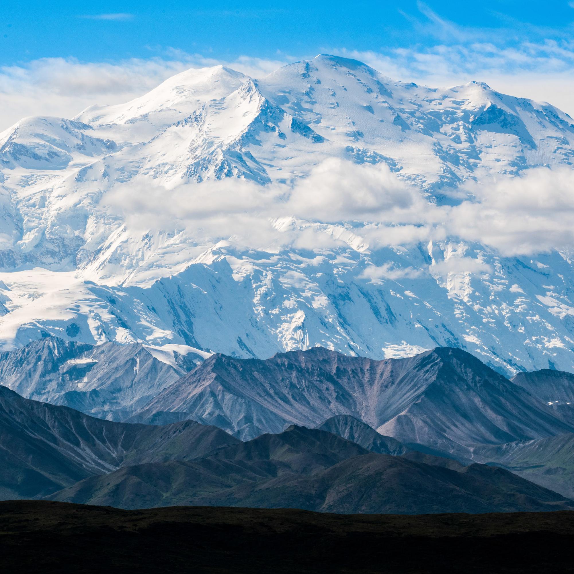 Snow-covered peak with smaller mountains in foreground