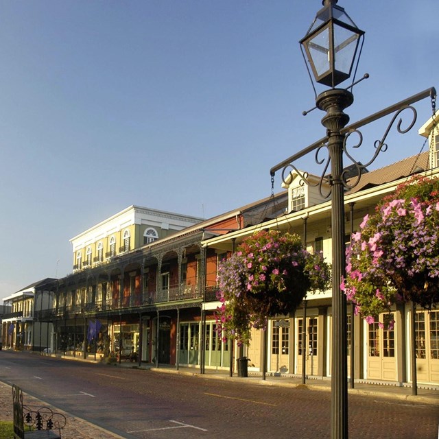 Front street in Natchitoches with building fronts having second floor balconies 