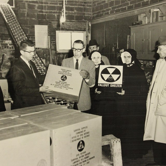 Period photograph of officials and nuns in a bomb shelter