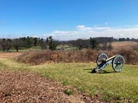 A cannon next to a mound covered with grass