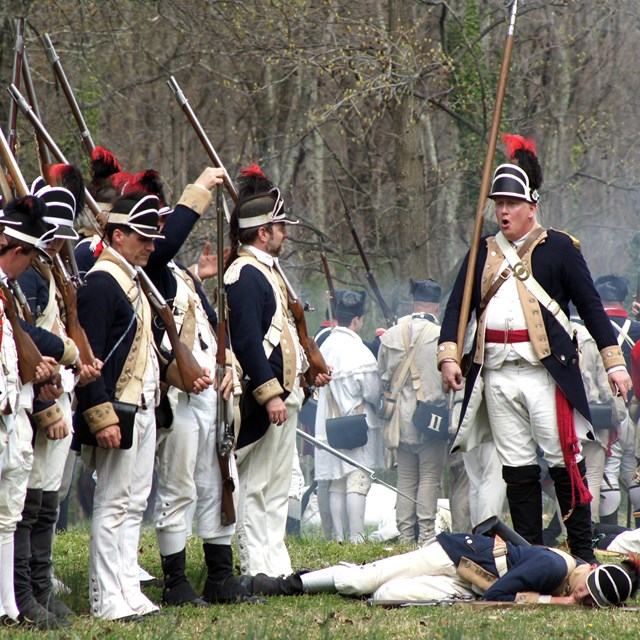American Revolution military reenactors in battle