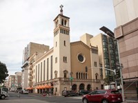 Tall, sand-colored church with a tower on a San Francisco corner