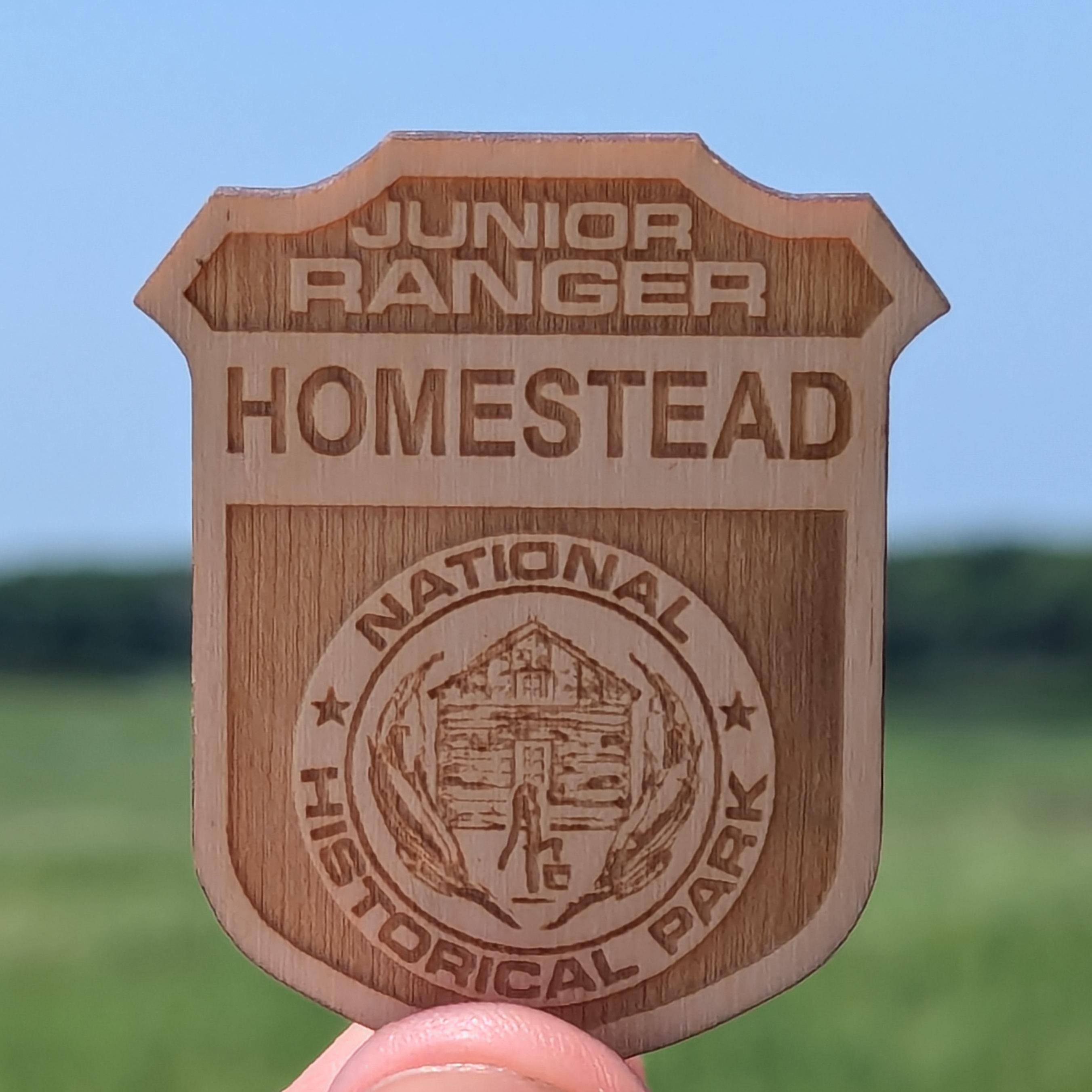 Wooden badge reading 
