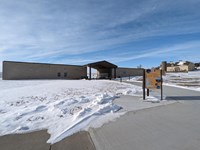 Visitor center with barn in background and kiosk in foreground