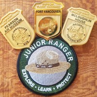 Three junior ranger badges and a patch.