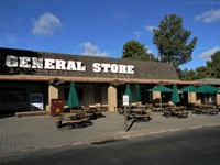 Large white letters reading General Store dominates the roof of a single story brown building
