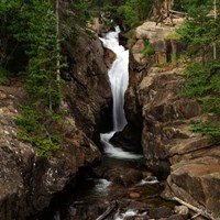 water cascading over a rocky cliff