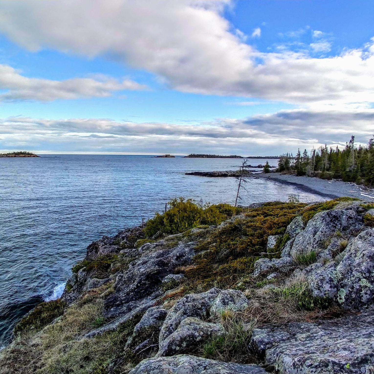 a view of the rocky Rock Harbor shoreline from the edge of the Stoll Memorial Trail