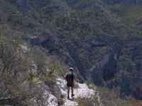 A hiker on a stony trail