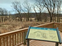 outdoors, trees, grass, earthworks, sign, railing